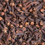 Clove (Syzygium aromaticum) texture, background. Used as a spice in cuisines all over the world. The plant is also used in medicine.